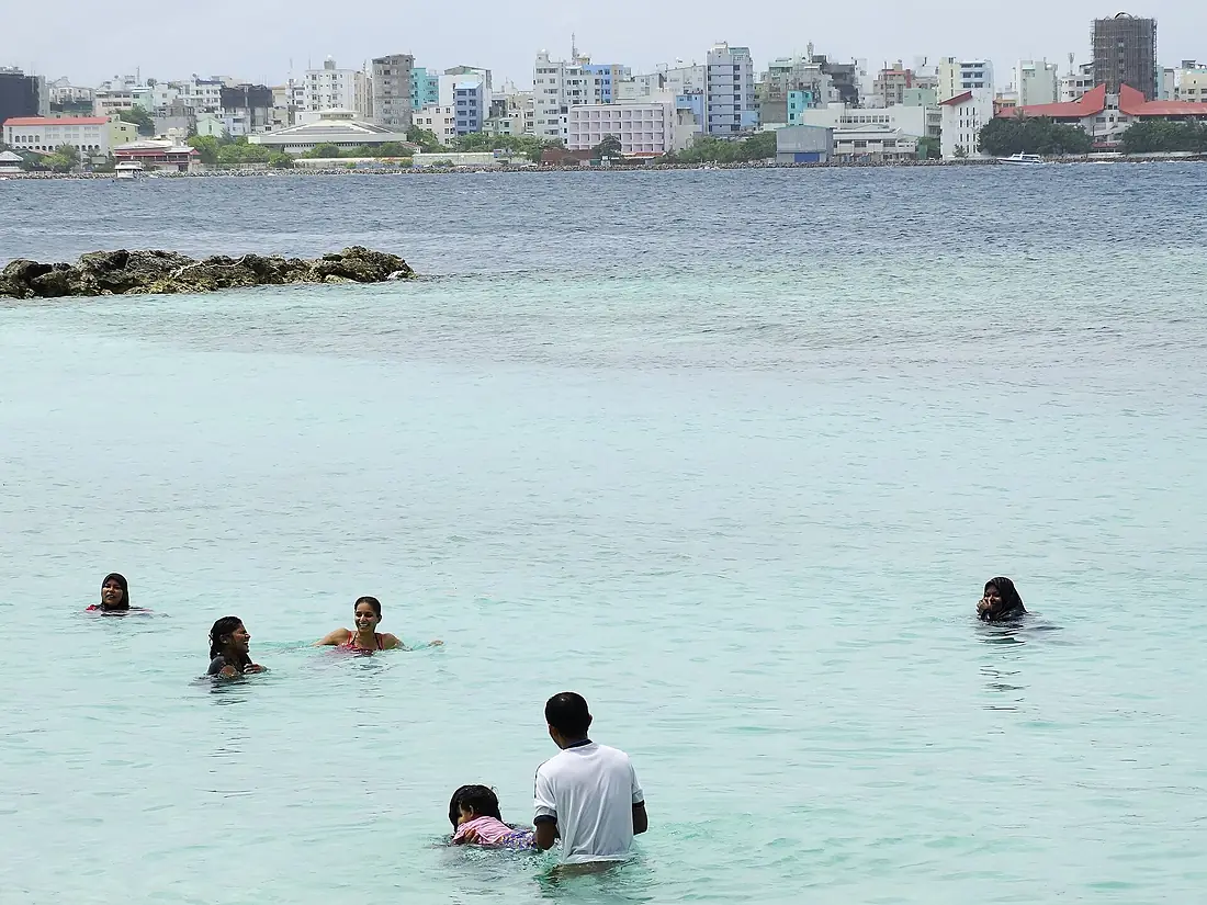 Paddlers with Male Skyline at Rear - Viliggili Island - Off Male - Maldives (14109454317)